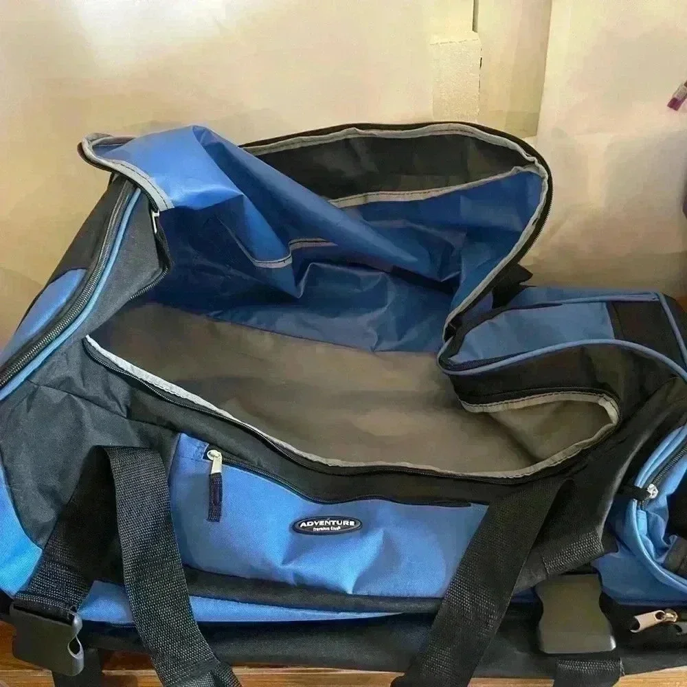 Adventure brand cargo travel‎ bag 30”L with several zipper pockets and wheels
